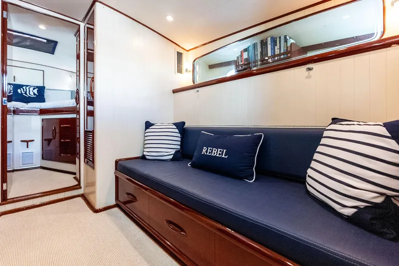 Rebel Yacht Photos Pics Luxurious 2000 Rybovich Sportfish interior with navy seating and striped pillows.