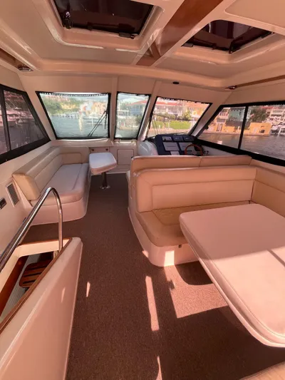 Team Yacht Photos Pics Luxurious interior of a 2007 Maritimo M60 yacht with spacious seating and panoramic windows.