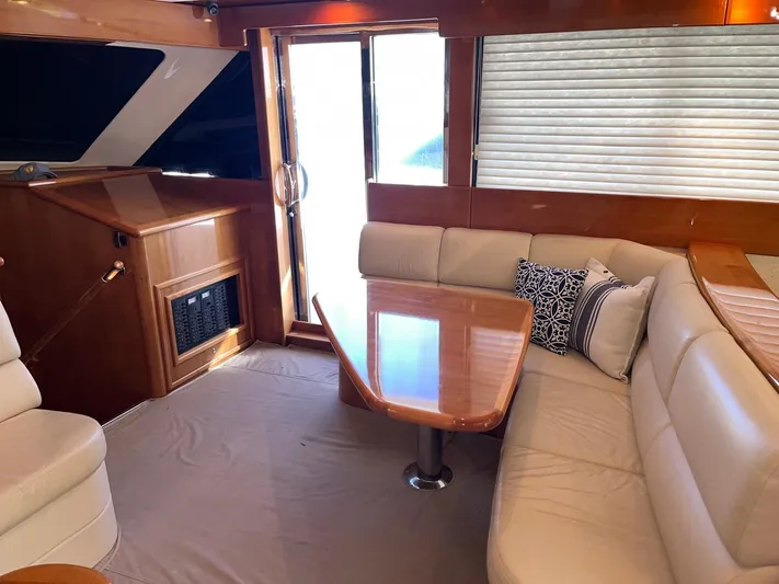 Team Yacht Photos Pics Luxurious interior of 2007 Maritimo M60 yacht with elegant seating and wooden table.