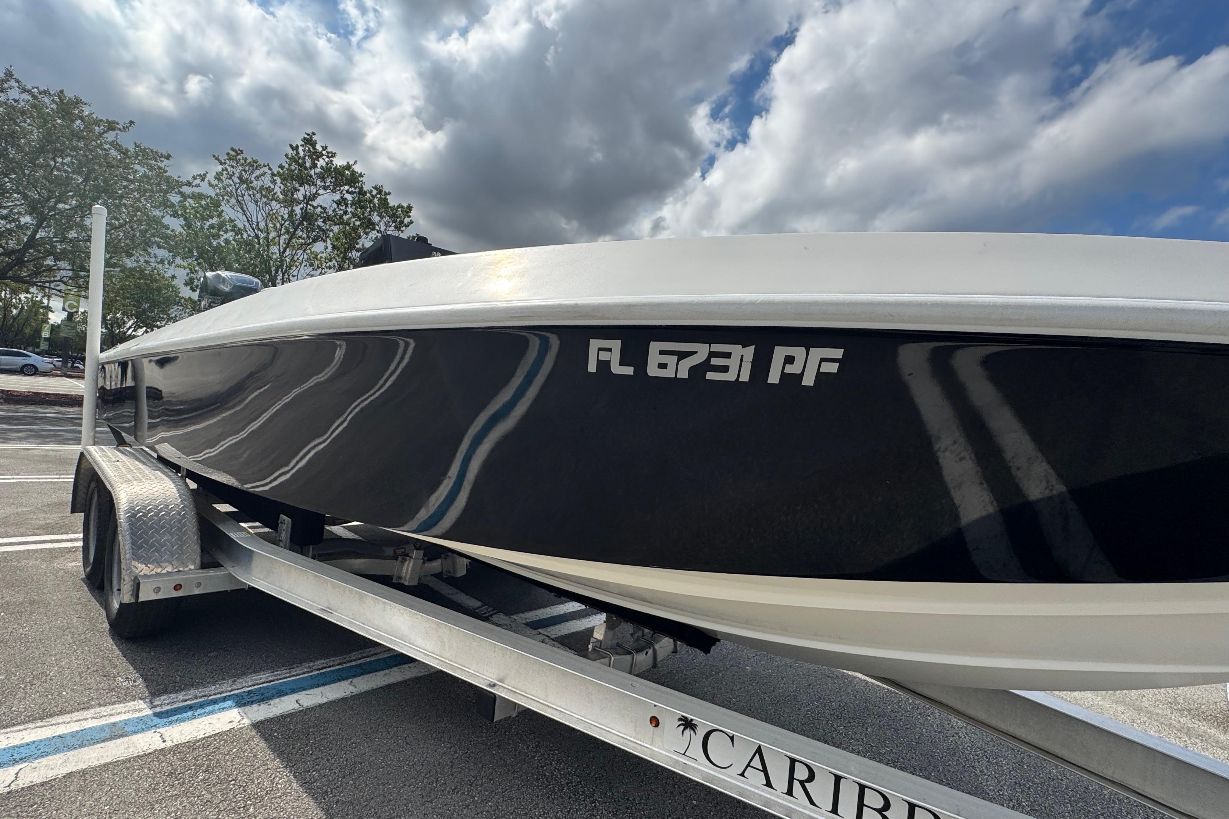 2010 Paramount Sportfisherman 21' boat on trailer under cloudy sky.