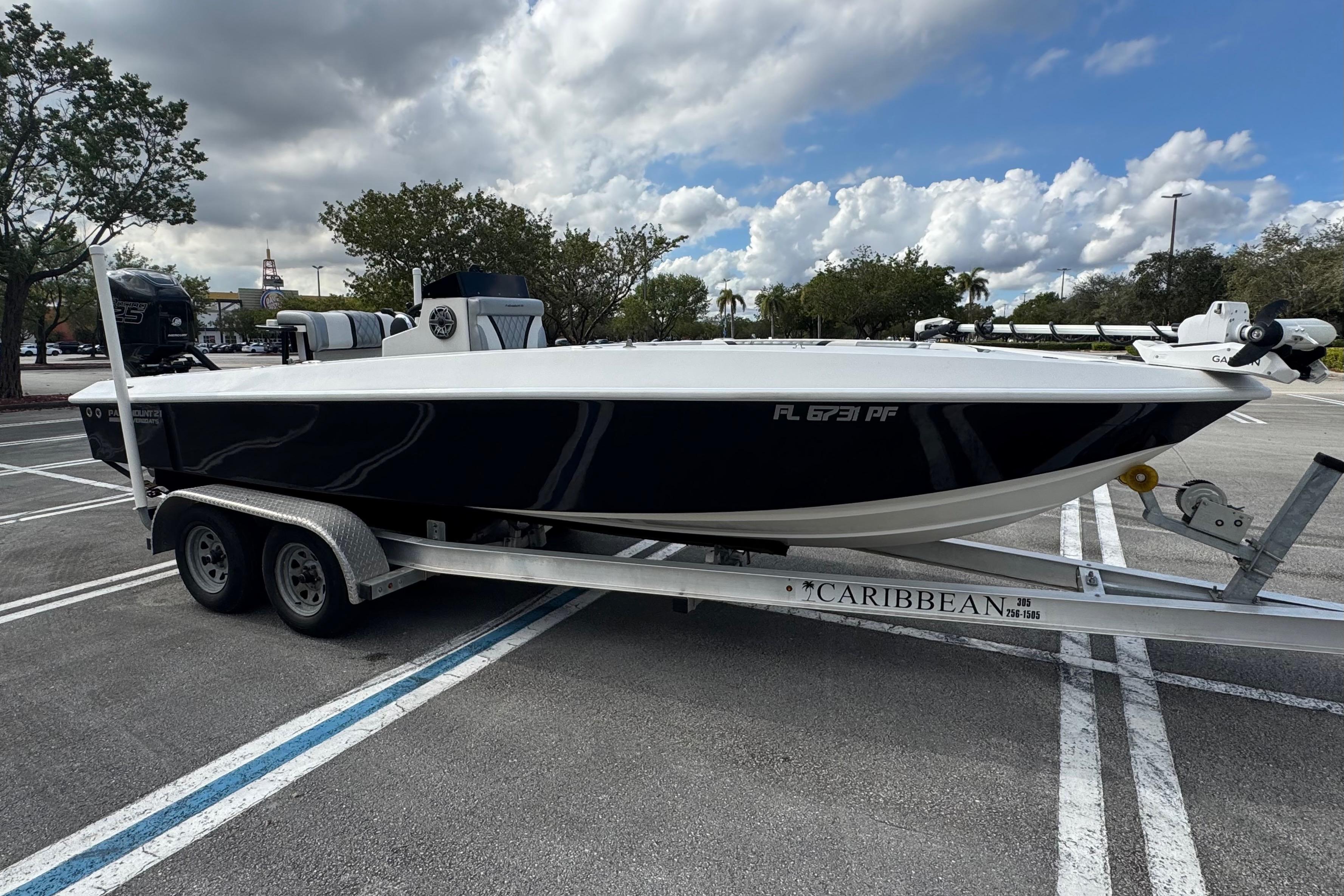 2010 Paramount Sportfisherman 21' boat on trailer in parking lot.