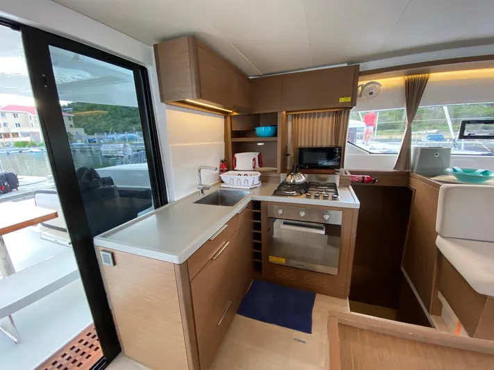 Out Of The Blue Yacht Photos Pics Modern kitchen interior of 2019 Lagoon 50 catamaran with sleek cabinetry and appliances.