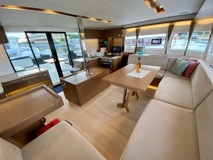 Out Of The Blue Yacht Photos Pics Luxurious interior of a 2019 Lagoon 50 catamaran with modern furnishings and ample seating.