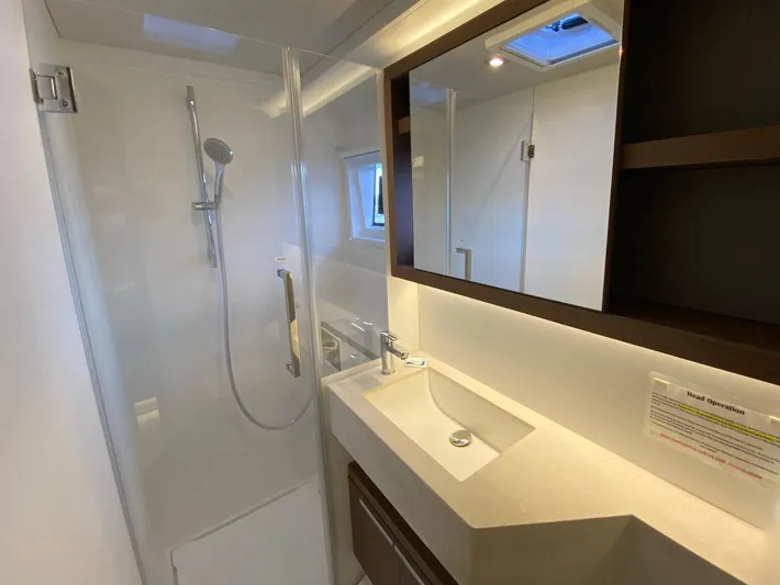 Out Of The Blue Yacht Photos Pics Modern bathroom interior on 2019 Lagoon 50 yacht, featuring shower and sleek vanity.