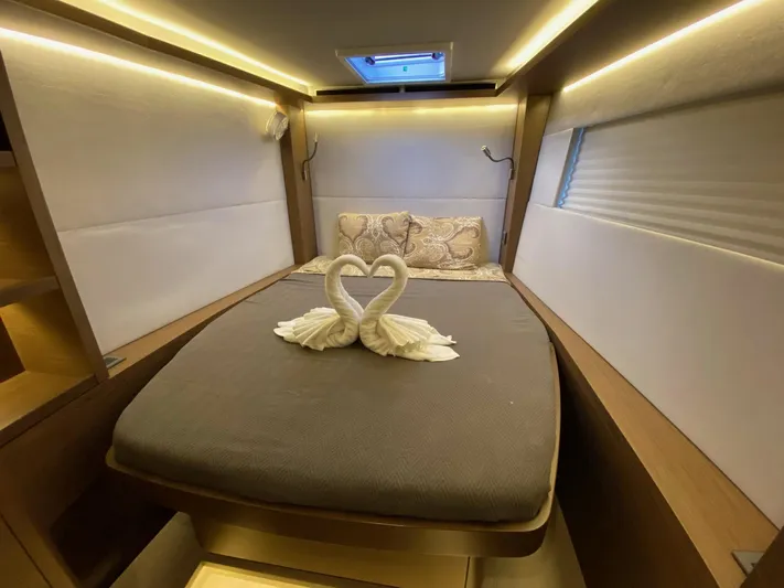 Out Of The Blue Yacht Photos Pics Luxurious cabin interior of 2019 Lagoon 50 yacht with elegant swan towel decor.