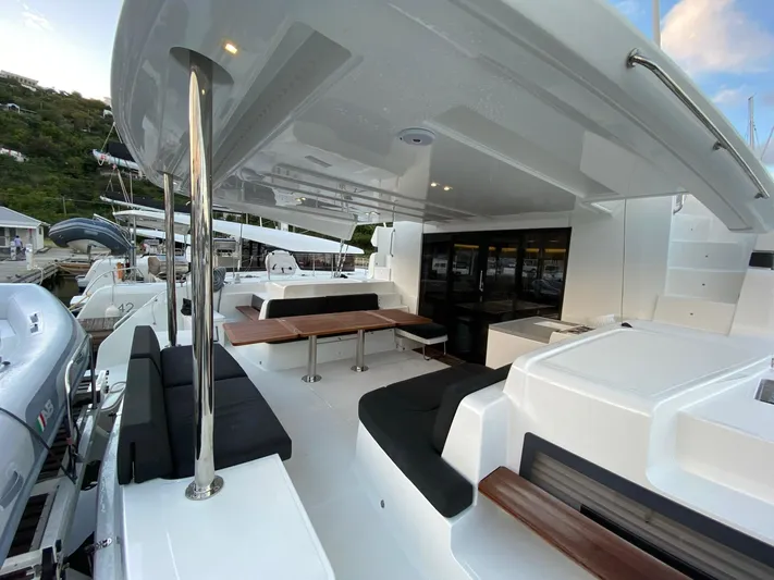 Out Of The Blue Yacht Photos Pics 2019 Lagoon 50 catamaran with spacious deck and seating area, docked at marina.