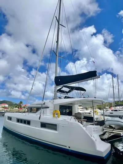 Out Of The Blue Yacht Photos Pics 2019 Lagoon 50 catamaran docked under a vibrant blue sky.