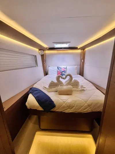 Out Of The Blue Yacht Photos Pics Luxurious cabin interior of 2019 Lagoon 50 yacht with elegant bedding and swan towel decor.
