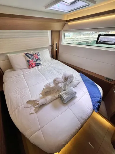 Out Of The Blue Yacht Photos Pics Luxurious cabin interior of 2019 Lagoon 50 yacht with elegant bedding and natural light.