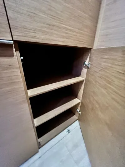 Out Of The Blue Yacht Photos Pics Wooden cabinet with open door and three shelves inside, Lagoon 50, 2019 model.