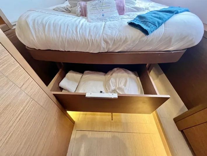 Out Of The Blue Yacht Photos Pics Under-bed storage in 2019 Lagoon 50 yacht cabin with linens and towels.