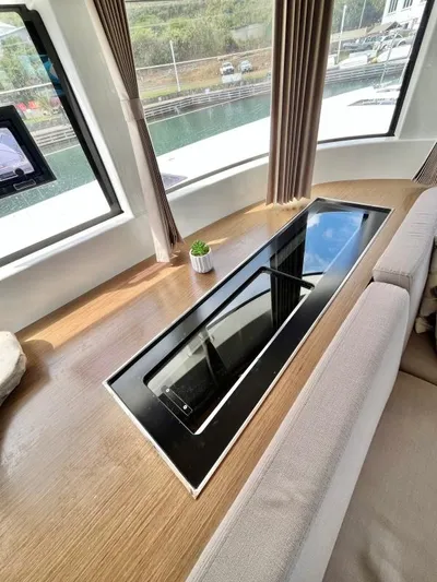 Out Of The Blue Yacht Photos Pics Interior of 2019 Lagoon 50 yacht with sleek table and panoramic windows.