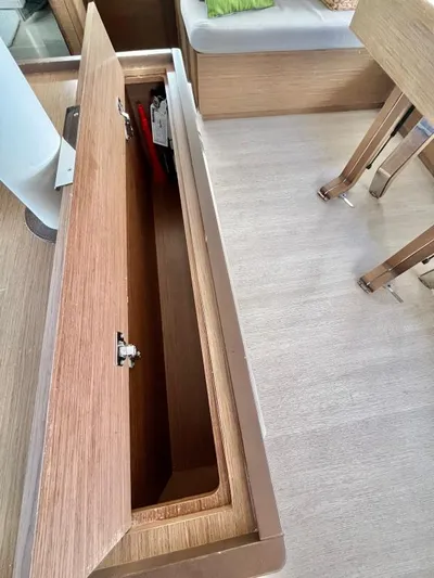 Out Of The Blue Yacht Photos Pics Open storage compartment in 2019 Lagoon 50 yacht interior with wooden finish.