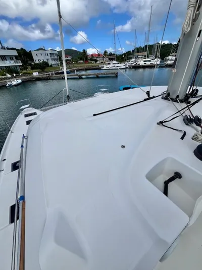Out Of The Blue Yacht Photos Pics 2019 Lagoon 50 catamaran docked in a marina, showcasing spacious deck and rigging.