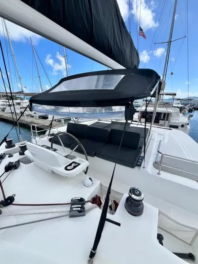 Out Of The Blue Yacht Photos Pics 2019 Lagoon 50 catamaran with sleek design, docked in marina under clear blue sky.