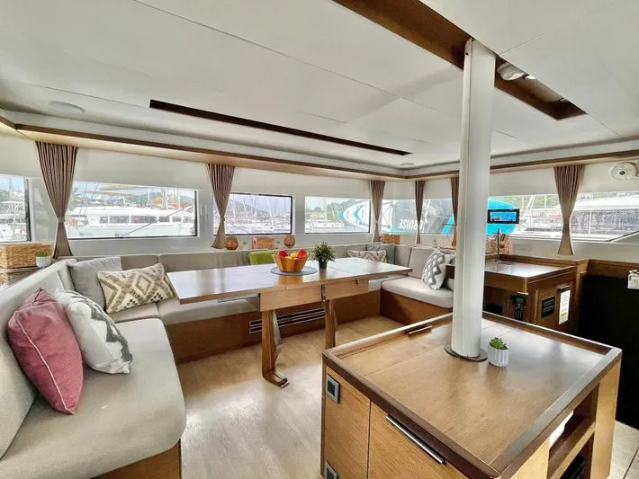 Out Of The Blue Yacht Photos Pics Luxurious interior of a 2019 Lagoon 50 catamaran with spacious seating and elegant decor.