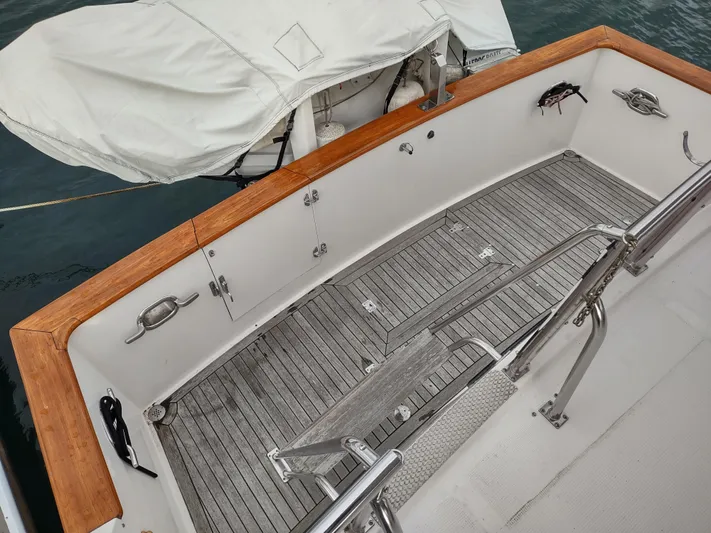 L' Espirit Yacht Photos Pics 1989 Ocean Alexander 440 CPMY boat deck with wooden trim and covered equipment.