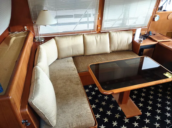 L' Espirit Yacht Photos Pics Luxurious 1989 Ocean Alexander 440 CPMY yacht interior with plush seating and elegant table.