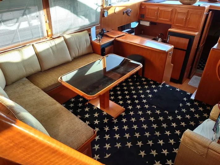 L' Espirit Yacht Photos Pics Luxurious 1989 Ocean Alexander 440 CPMY yacht interior with plush seating and star-patterned carpet.