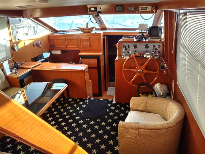 L' Espirit Yacht Photos Pics 1989 Ocean Alexander 440 CPMY yacht interior with wood finish and star-patterned carpet.