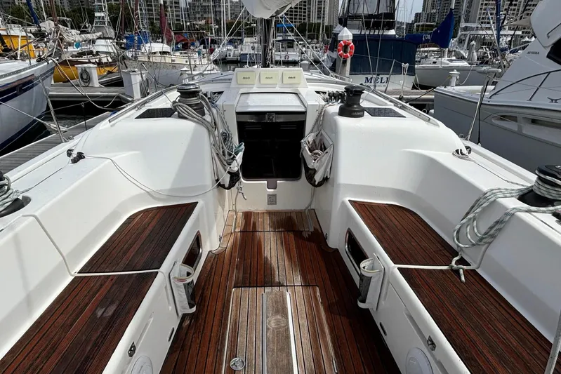 Vamoosh Yacht Photos Pics 2012 X-Yachts XP-44 sailboat cockpit with wooden deck and marina background.