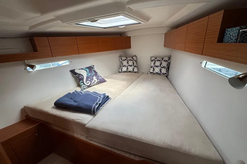 Vamoosh Yacht Photos Pics Luxurious cabin interior of 2012 X-Yachts XP-44 with cozy bedding and elegant wood finish.