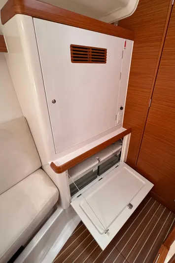 Vamoosh Yacht Photos Pics Interior of 2012 X-Yachts XP-44, featuring wooden cabinetry and open storage compartment.