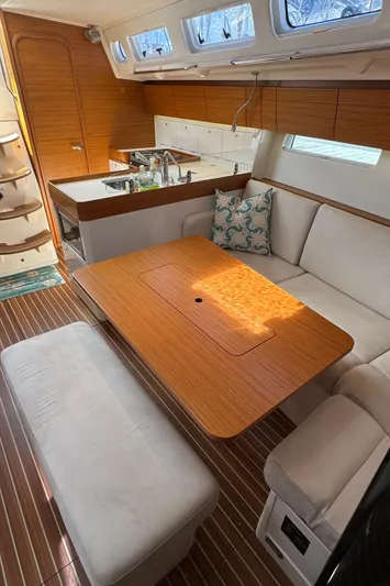 Vamoosh Yacht Photos Pics Interior of 2012 X-Yachts XP-44 sailboat with wooden table and white seating.