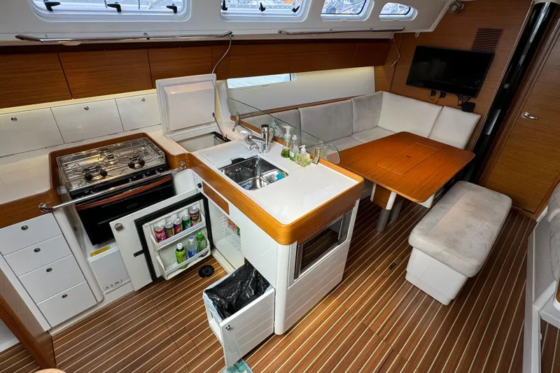 Vamoosh Yacht Photos Pics Luxurious 2012 X-Yachts XP-44 interior with modern kitchen and cozy seating area.
