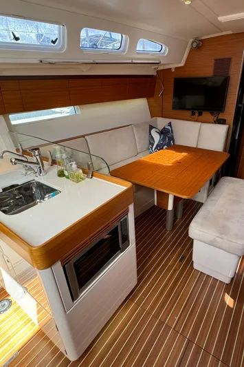 Vamoosh Yacht Photos Pics 2012 X-Yachts XP-44 interior with modern kitchen, dining area, and wooden flooring.