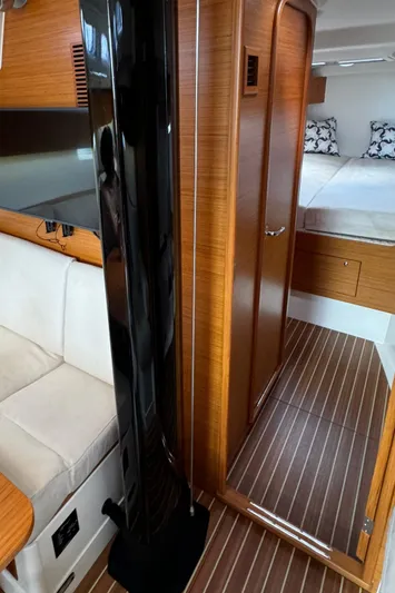 Vamoosh Yacht Photos Pics Interior of 2012 X-Yachts XP-44, featuring wood paneling and cozy seating area.