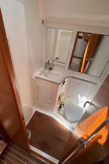 Vamoosh Yacht Photos Pics 2012 X-Yachts XP-44 bathroom with sink, mirror, and wooden flooring.