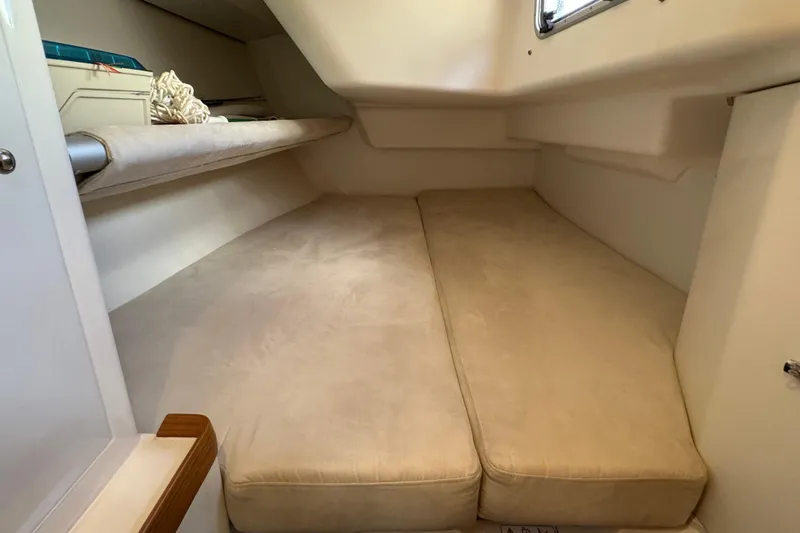 Vamoosh Yacht Photos Pics Cozy cabin interior of 2012 X-Yachts XP-44 with beige cushions and storage space.