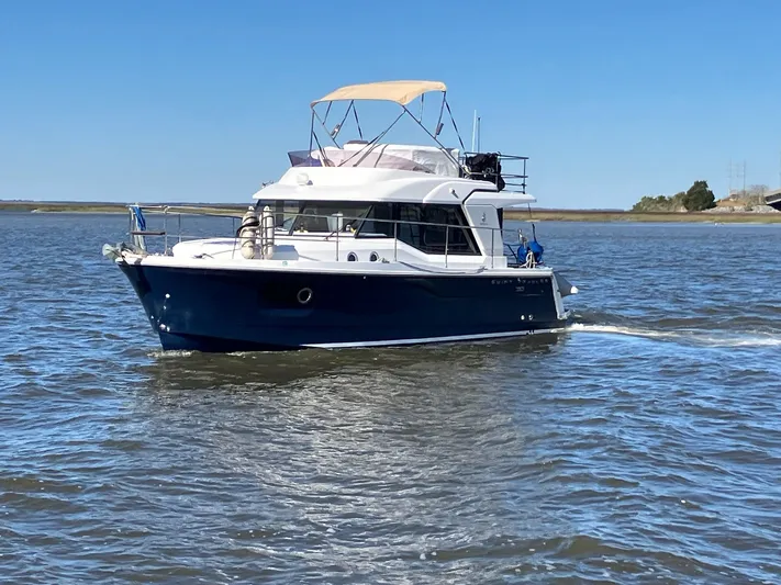 Blue Bird Yacht Photos Pics 2017 Beneteau Swift Trawler 30 cruising on open water under clear blue skies.