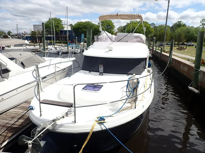 Blue Bird Yacht Photos Pics 2017 Beneteau Swift Trawler 30 docked at marina, featuring sleek design and spacious deck.