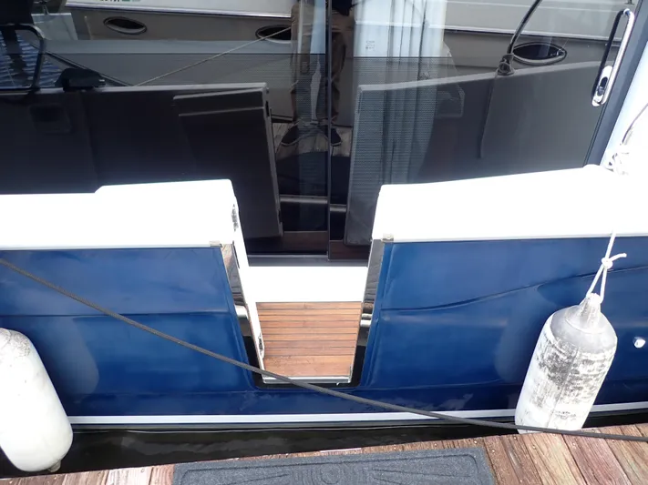 Blue Bird Yacht Photos Pics 2017 Beneteau Swift Trawler 30, blue hull, docked with fenders and mooring line.