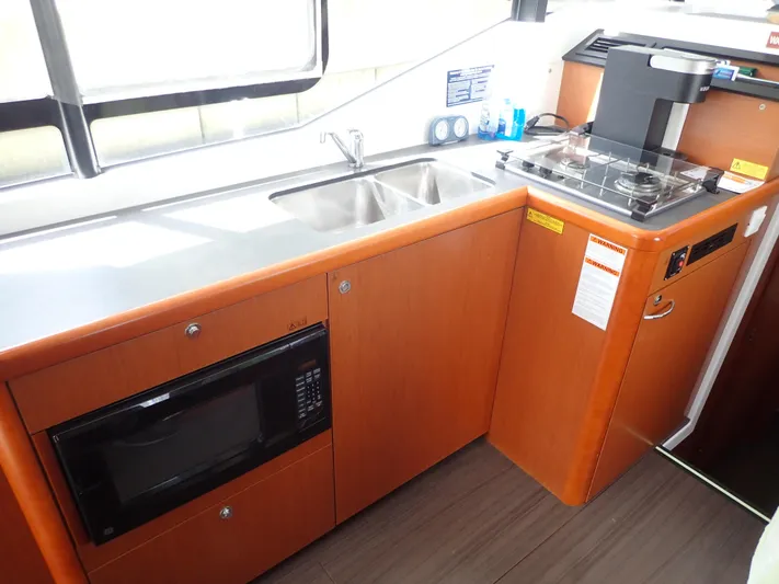 Blue Bird Yacht Photos Pics 2017 Beneteau Swift Trawler 30 kitchen with sink, stove, and microwave.