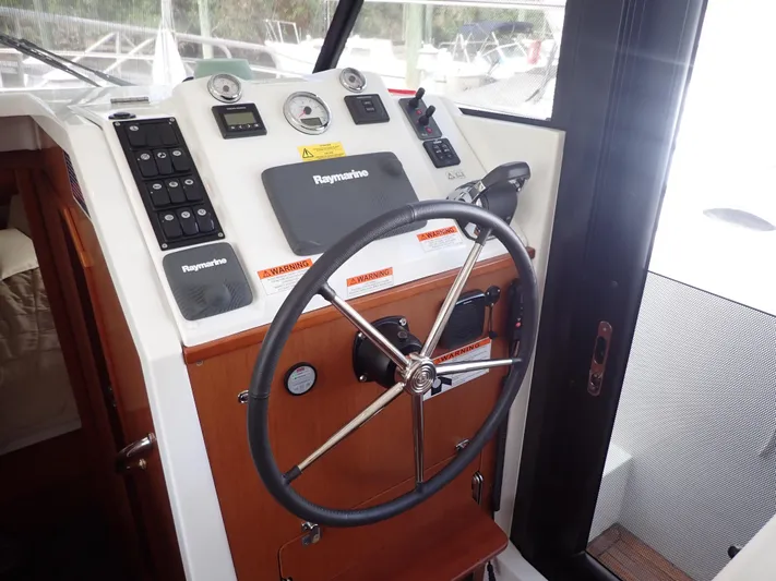 Blue Bird Yacht Photos Pics 2017 Beneteau Swift Trawler 30 helm with Raymarine navigation and steering wheel.