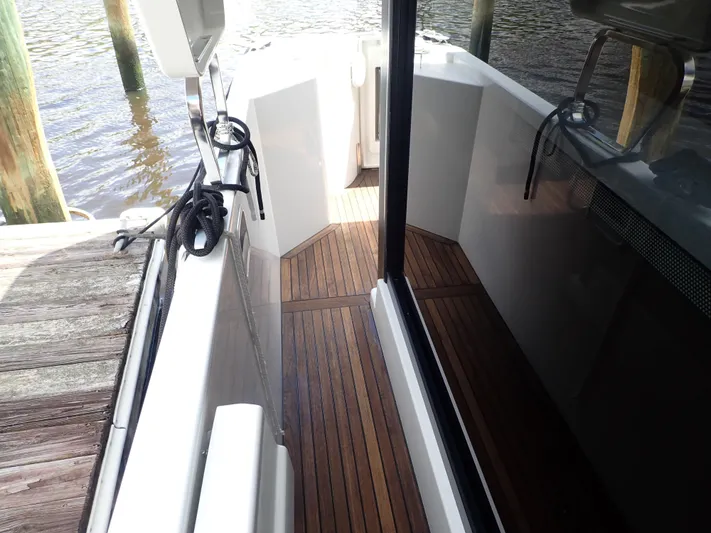 Blue Bird Yacht Photos Pics 2017 Beneteau Swift Trawler 30 with teak deck, docked by wooden pier.