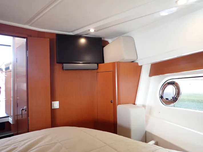 Blue Bird Yacht Photos Pics Interior cabin of 2017 Beneteau Swift Trawler 30 with TV and porthole window.