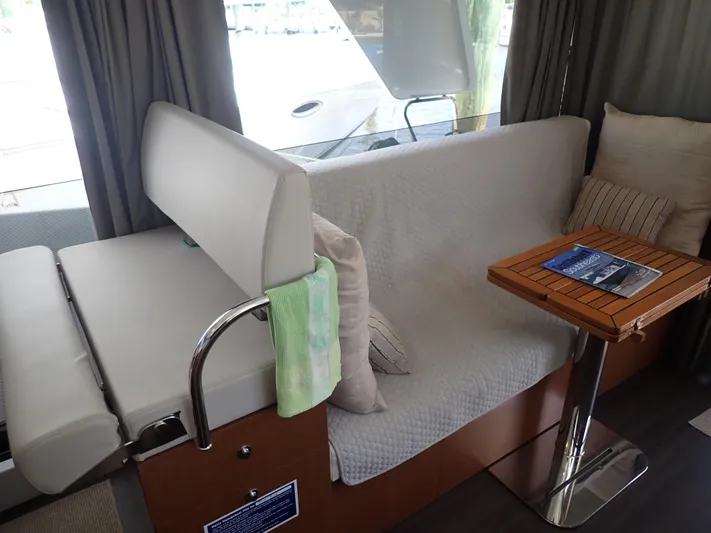Blue Bird Yacht Photos Pics Interior of 2017 Beneteau Swift Trawler 30 with seating and wooden table.