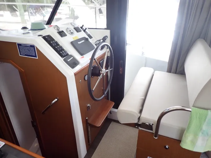 Blue Bird Yacht Photos Pics 2017 Beneteau Swift Trawler 30 helm station with steering wheel and control panel.