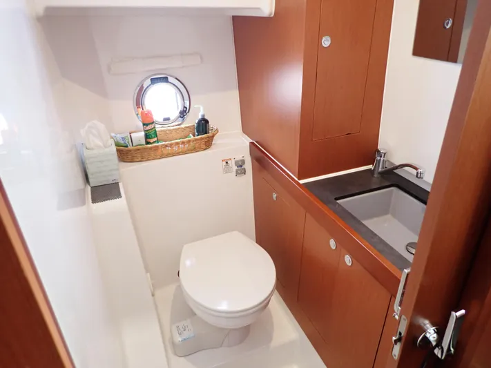 Blue Bird Yacht Photos Pics 2017 Beneteau Swift Trawler 30 bathroom with wooden cabinetry and modern fixtures.