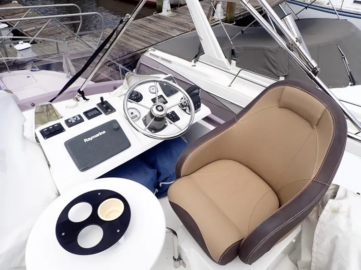 Blue Bird Yacht Photos Pics 2017 Beneteau Swift Trawler 30 helm with steering wheel and comfortable captain's chair.