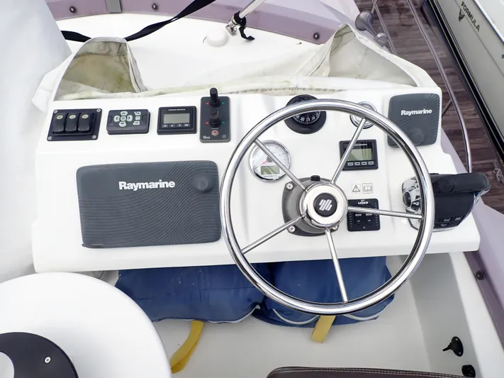 Blue Bird Yacht Photos Pics Helm of 2017 Beneteau Swift Trawler 30 with Raymarine electronics and steering wheel.