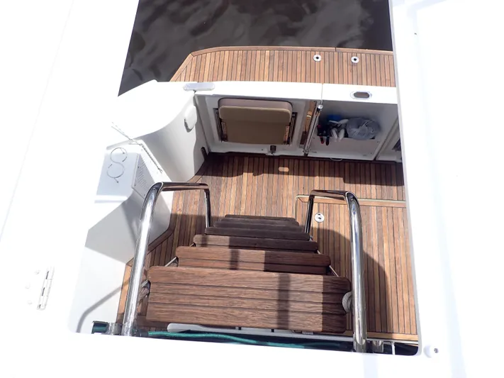 Blue Bird Yacht Photos Pics Staircase on 2017 Beneteau Swift Trawler 30 with wooden deck and stainless steel railings.