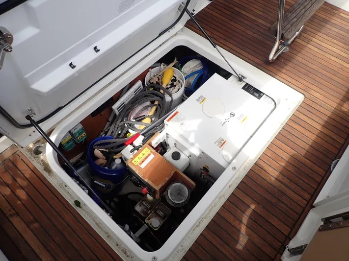 Blue Bird Yacht Photos Pics 2017 Beneteau Swift Trawler 30 engine compartment with equipment and storage on teak deck.