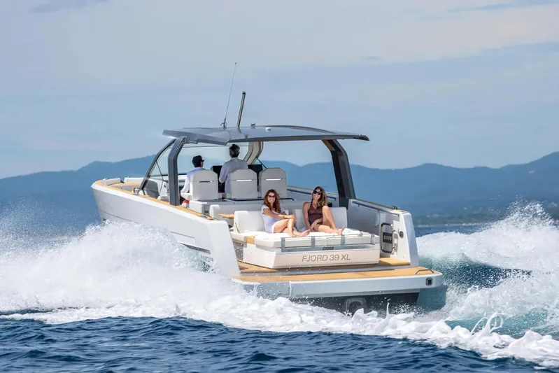  Yacht Photos Pics 2026 Fjord 39 XL yacht cruising on open water with passengers relaxing.