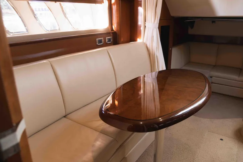  Yacht Photos Pics Luxurious interior of 2008 Sea Ray 38 Sundancer yacht with elegant seating and wooden table.