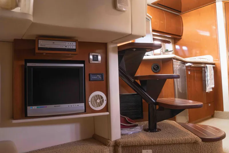  Yacht Photos Pics Interior of 2008 Sea Ray 38 Sundancer yacht with TV, DVD player, and wooden stairs.